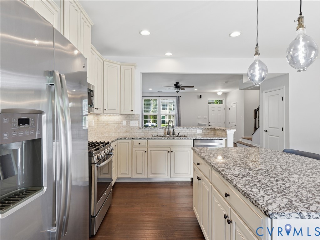 Light cabinetry, granite countertops, and stainless steel appliances give the kitchen a clean, classic look.