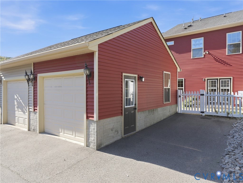 Detached one-car garage provides convenient parking and additional storage for this Richmond townhome