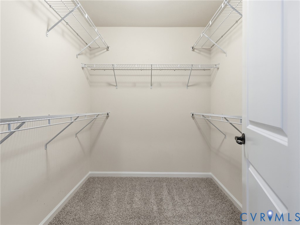 Generously sized walk-in closet with shelving