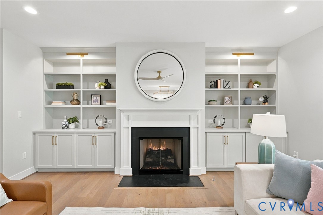 The Custom Bookcases Include Picture Lights & the Gas Fireplace Perfect for Chilly Nights