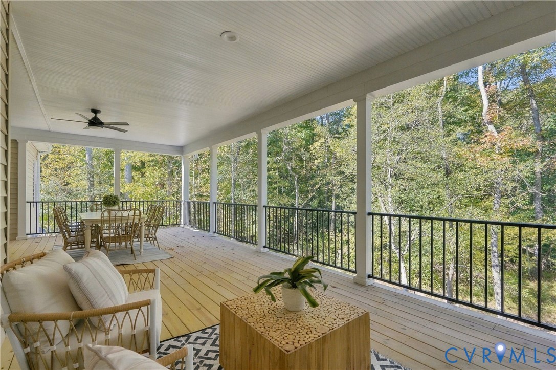 The Covered Porch has Black Aluminum Rails, Concrete Columns, Recessed Lighting & Remote Controlled Fan/Light