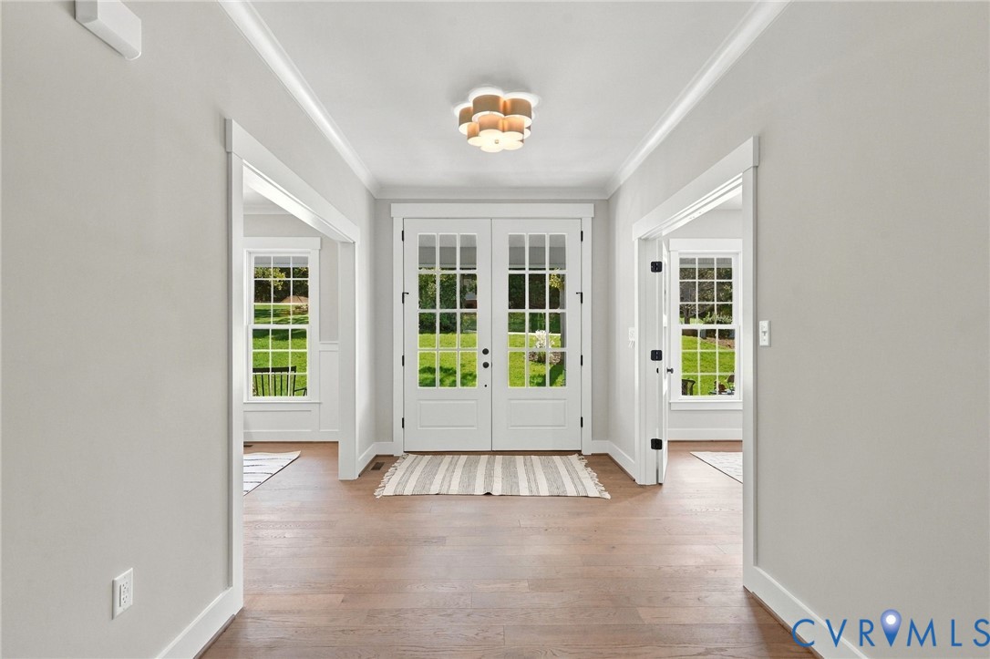 Stunning Foyer has Hardwood & Sets Tone for Custom Built Home