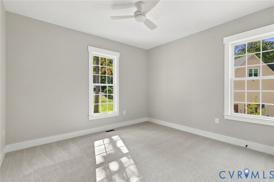 Bedroom 2 on Front of Home has Carpet & Large Windows Providing Natural Light