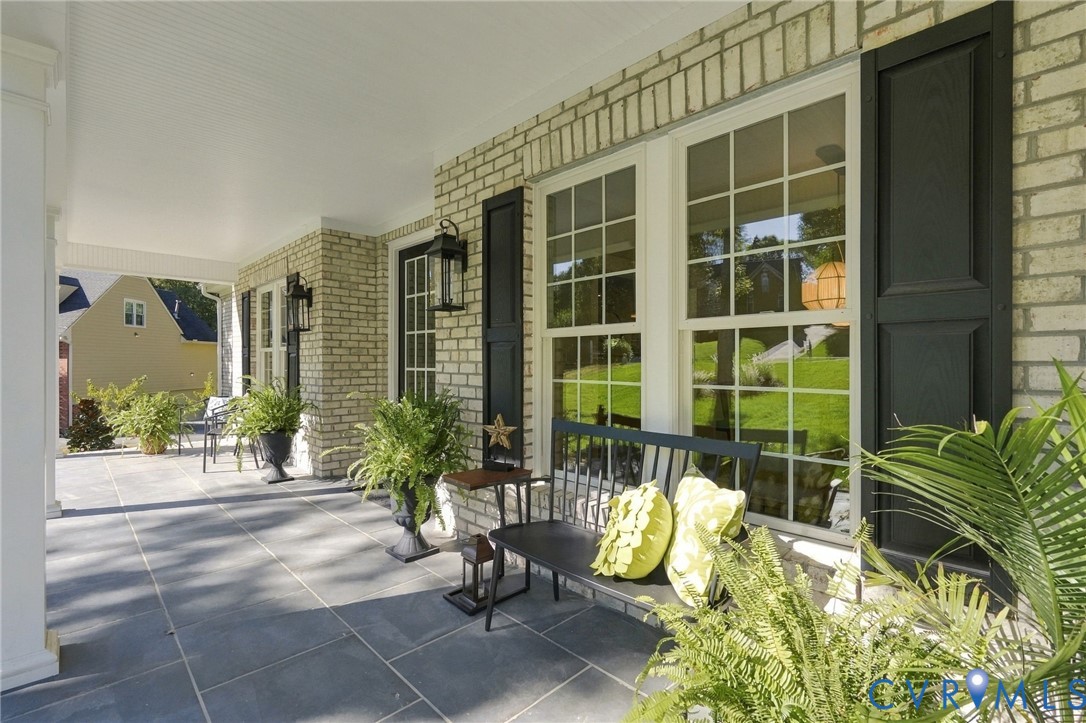 Concret Columns, Brick Steps, Black Shutters & Light Fixtures Make This Feel Like Home