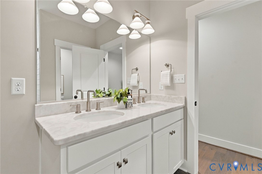 Upgraded Lighting and Brushed Nickel Accents Complete the Hall Bath
