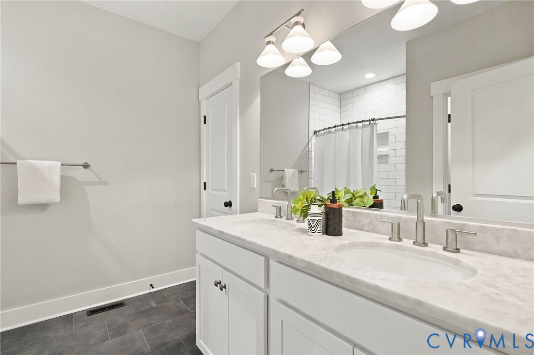 The Hall Bathroom has an Adult Height Double Bowl Vanity w/Marble Top