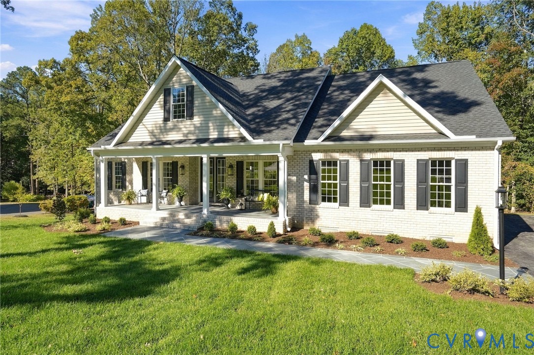 The Custom Built Home Features 3-Sided Brick, Architectural Columns & Custom Designed Slate Look Porch & Sidewalk and Professional Landscaping