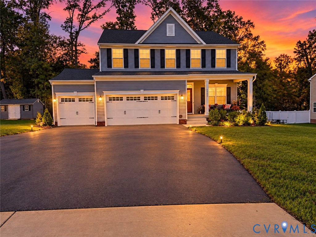 Two-story residence with a covered porch, two-car garage, and a separate shed structure Two-story residence with a covered porch, two-car garage, and a separate shed structure