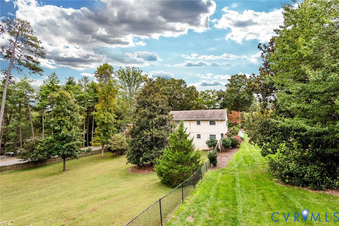 Nearly an acre of privacy, this sweeping lawn provides ample space for recreation and relaxation.
