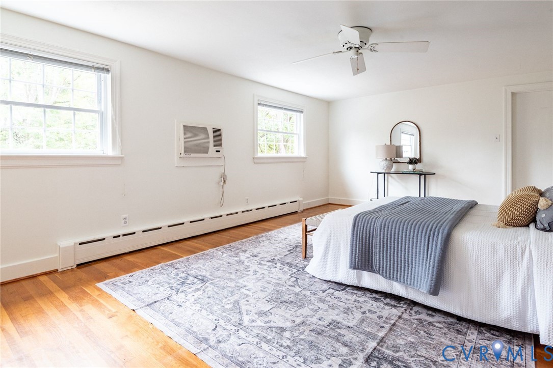 Fourth of five bedrooms with hardwood floors and walk-in attic for expansion opportunities or significant storage.