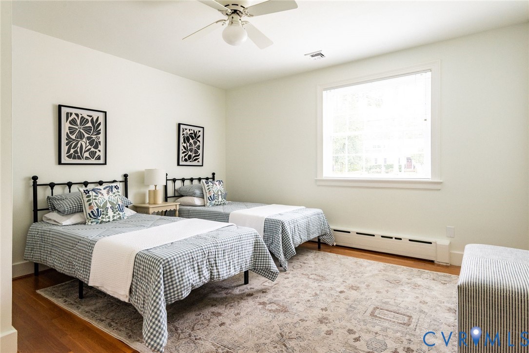 Third of five bedrooms with hardwood floors and nearby full hall bath.