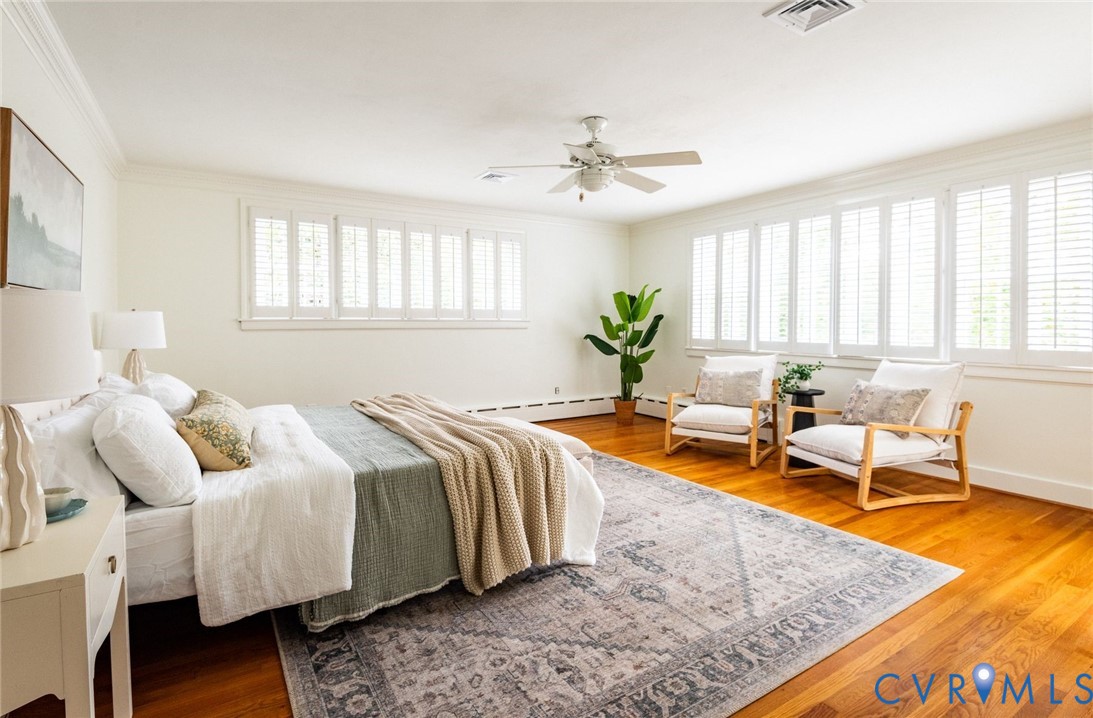 Private primary ensuite with hardwood floors, banks of windows providing bright natural light, walk-in closet and sizable ensuite bathroom. Private primary ensuite with hardwood floors, banks of windows providing bright natural light, walk-in closet and sizable ensuite bathroom.