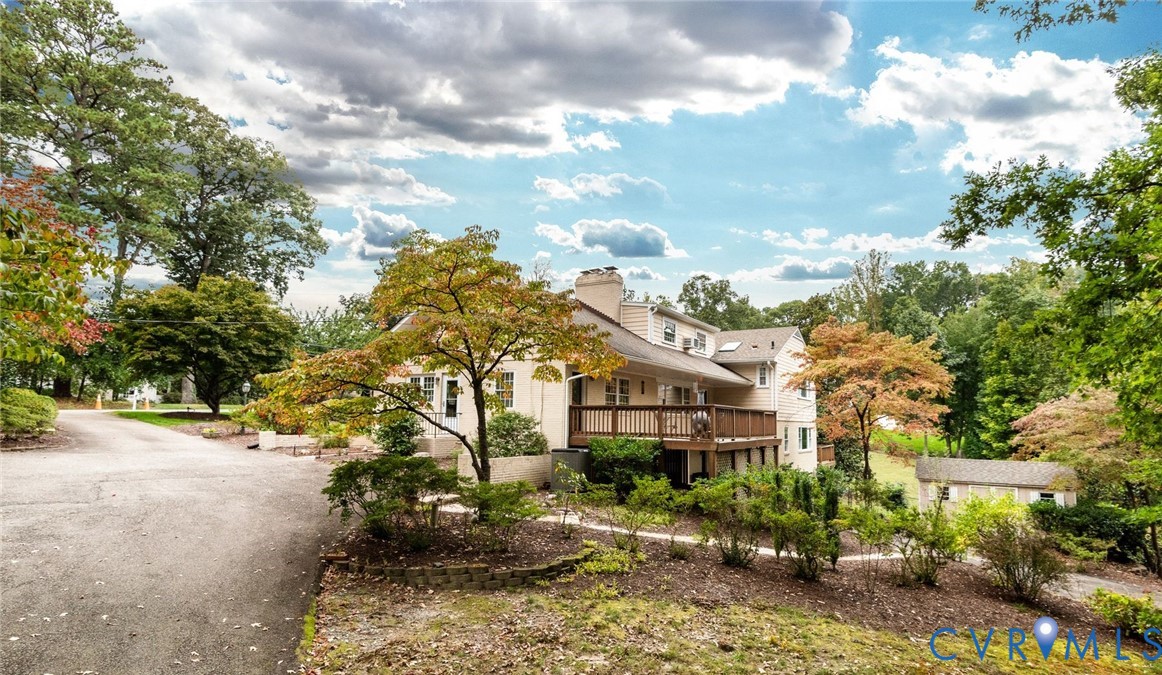 Circular paved driveway with designated parking and entry access directly to the kitchen, slate walkway to the front entry and an additional rear driveway with access to the 1-car garage.