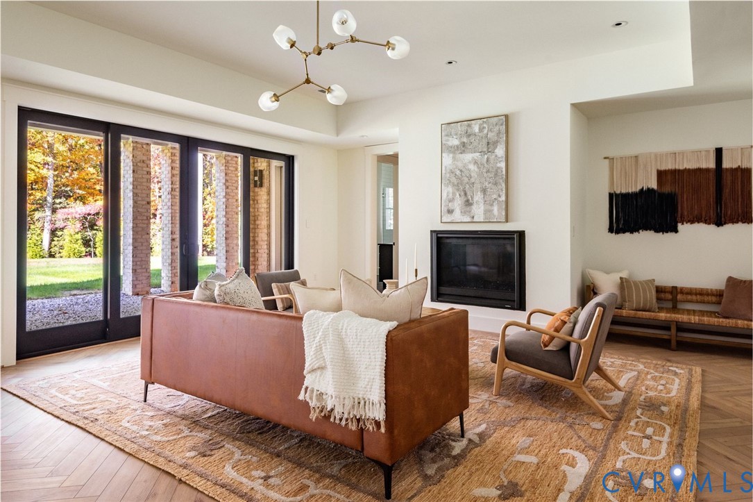 Lower level rec room with kitchen, dining, full bath, sliders to outside, abundant storage closets, gas fireplace and herringbone floors.
