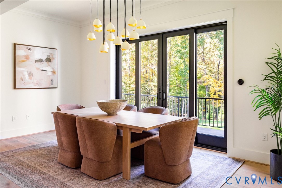 Random-width hardwoods, sliders to deck overlooking private fenced grounds, open to kitchen and living areas.