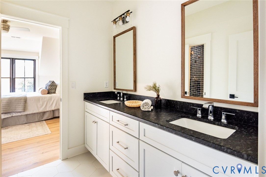 Private 3rd bedroom ensuite bathroom with hall access as well, custom vanity, glass shower and designer tile.