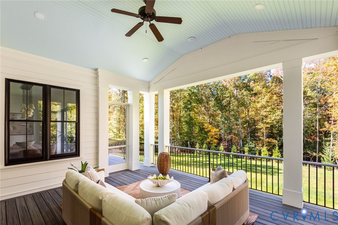 Covered deck overlooking private fenced grounds, vaulted ceiling, access to great room.