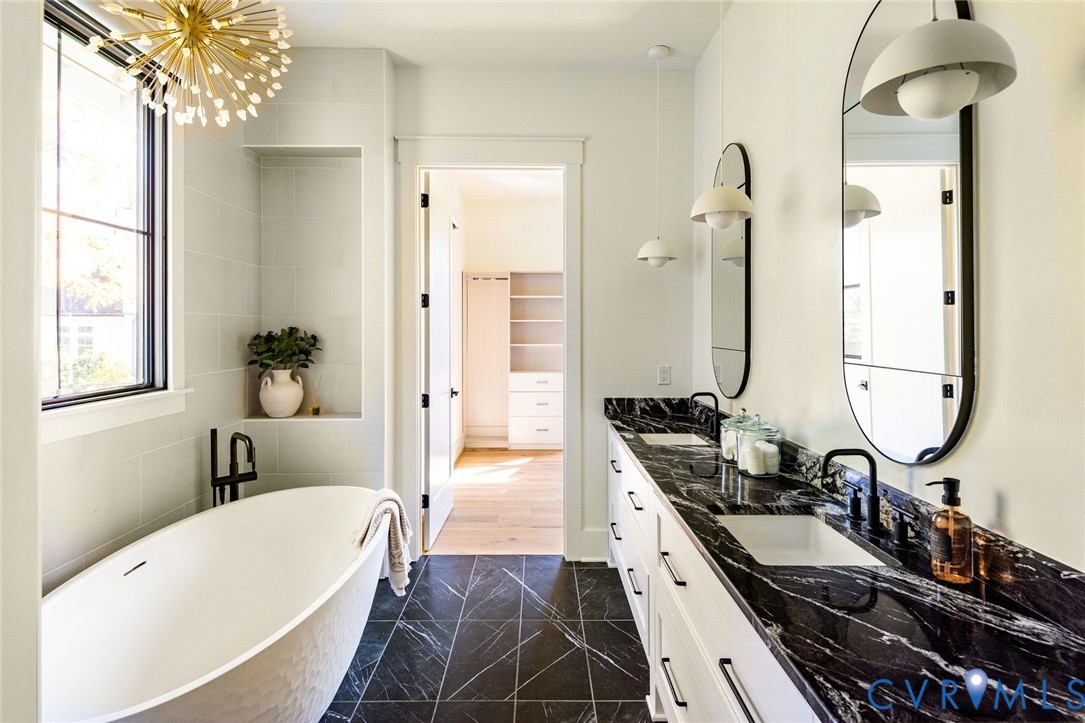 Spa-inspired primary ensuite with Kallista soaking tub, custom vanity and walk-in closet.