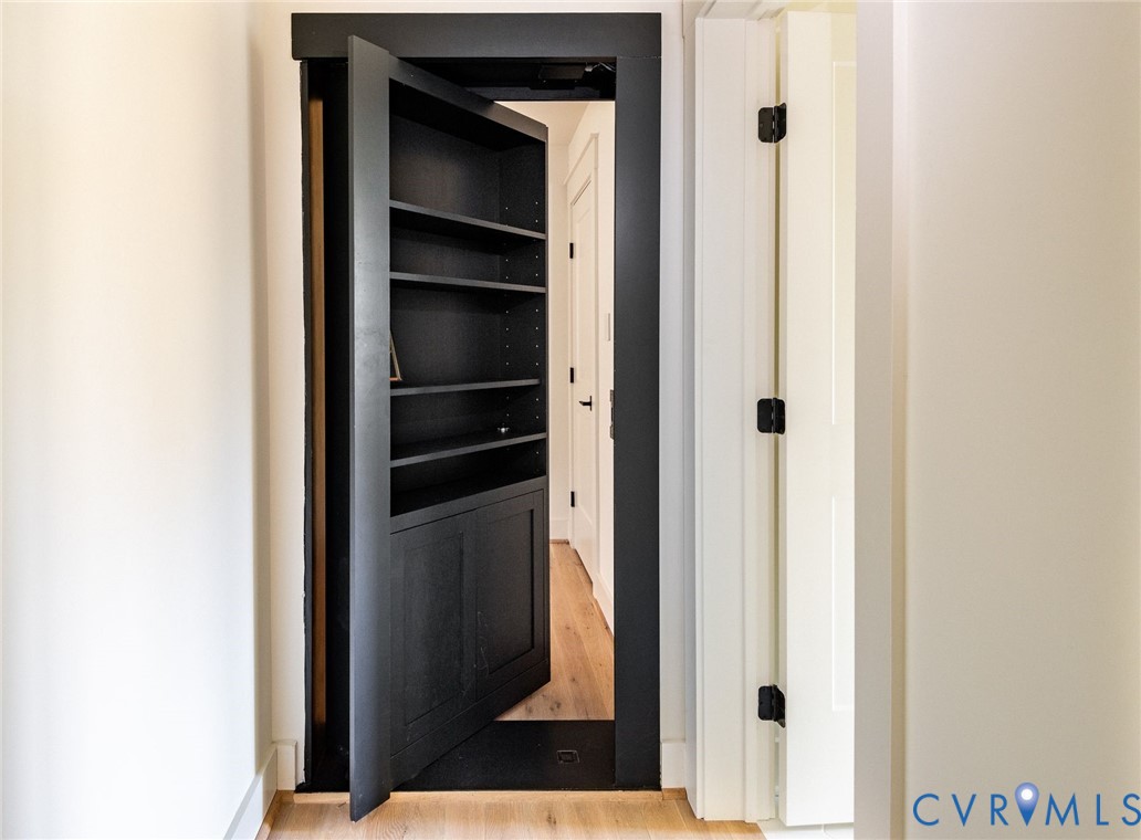 Custom bookcase Murphy door leading to versatile bonus space.