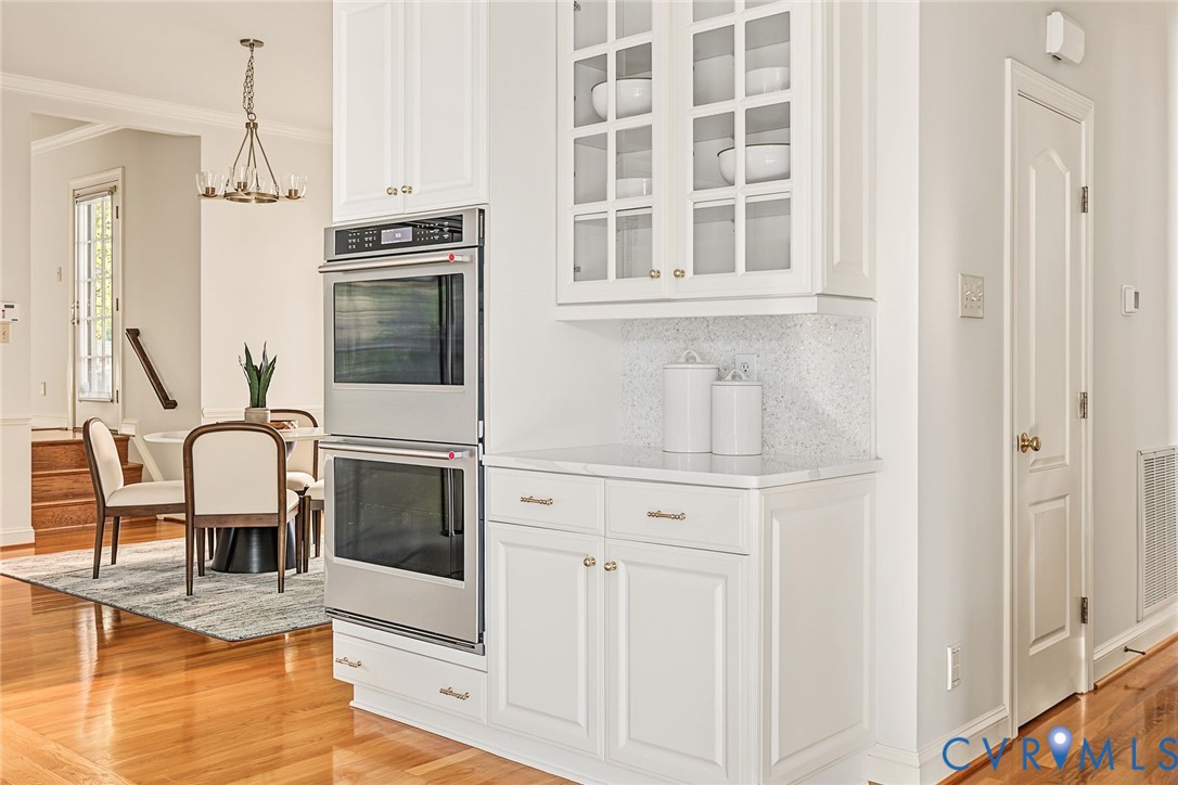 Ample cabinetry, pantry and full wet bar with seating area create a harmonious layout.