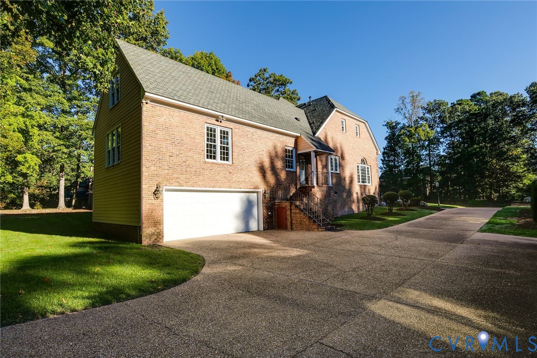 Double width driveway leads to a two car garage with bonus storage room.