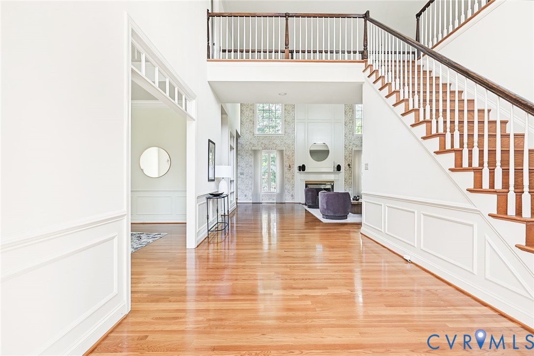 Cathedral ceilings, floor to ceiling windows, wainscoting and hardwoods provide a sophisticated entrance.