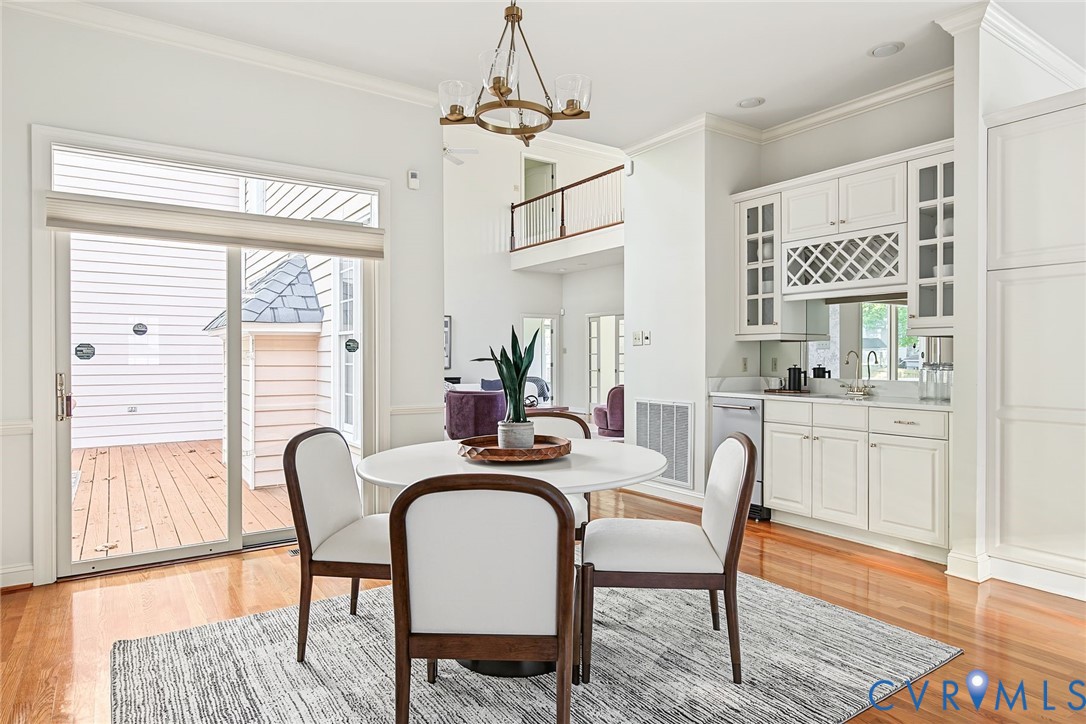 The wet bar with chic lighting is ideal for hosting game night or parties.