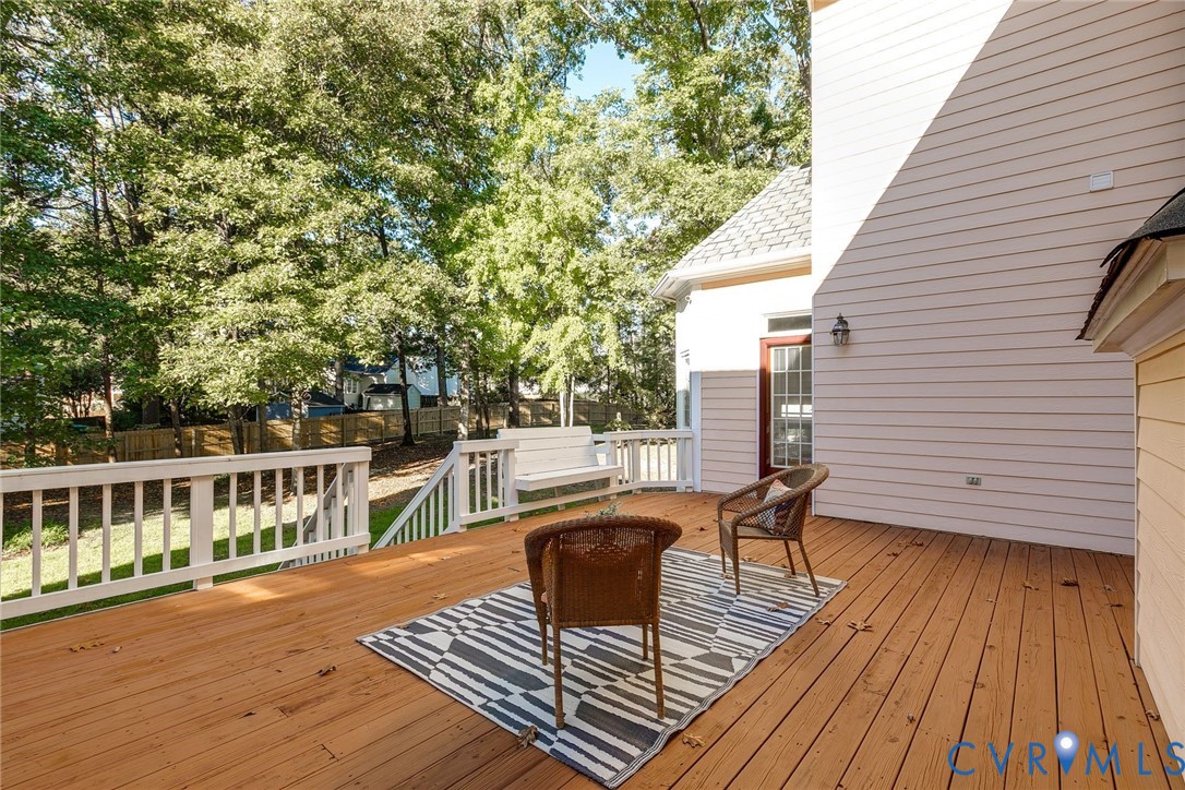 Step onto the back deck to discover a peaceful tree lined back yard.