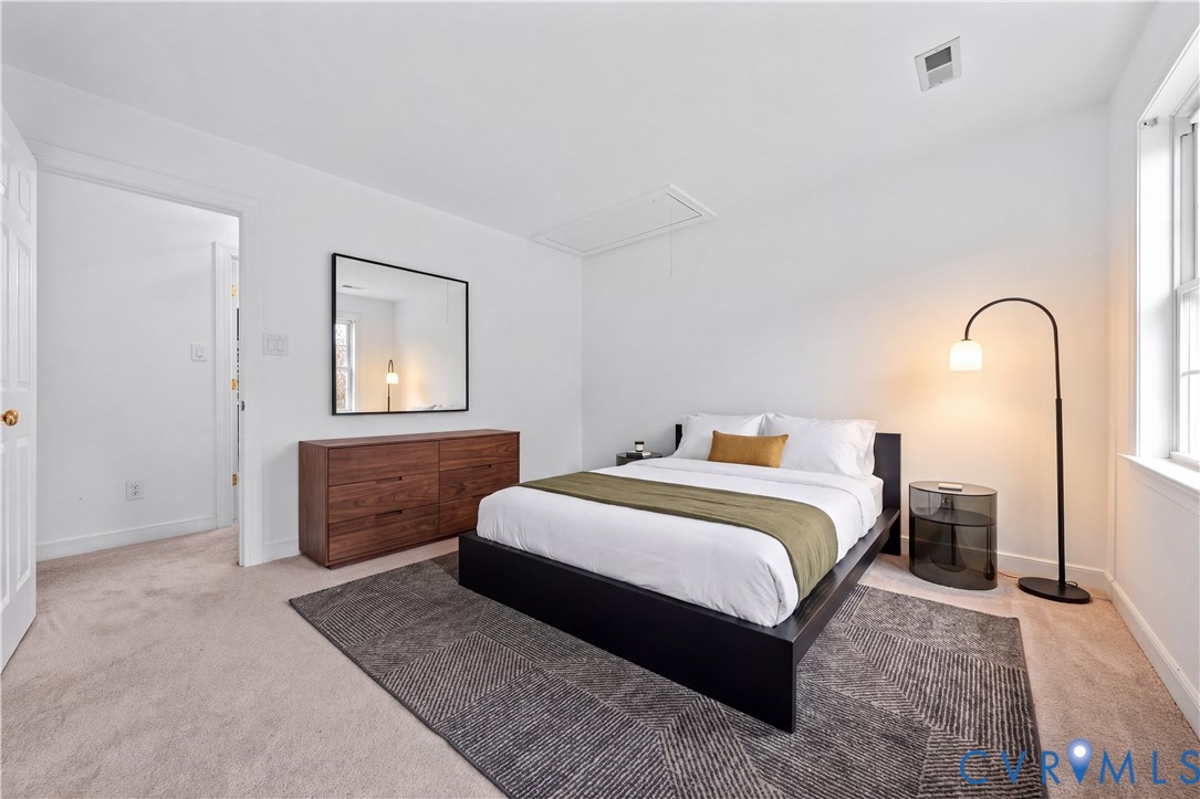 Neutral wall color, carpeted flooring, and a multi-pane window