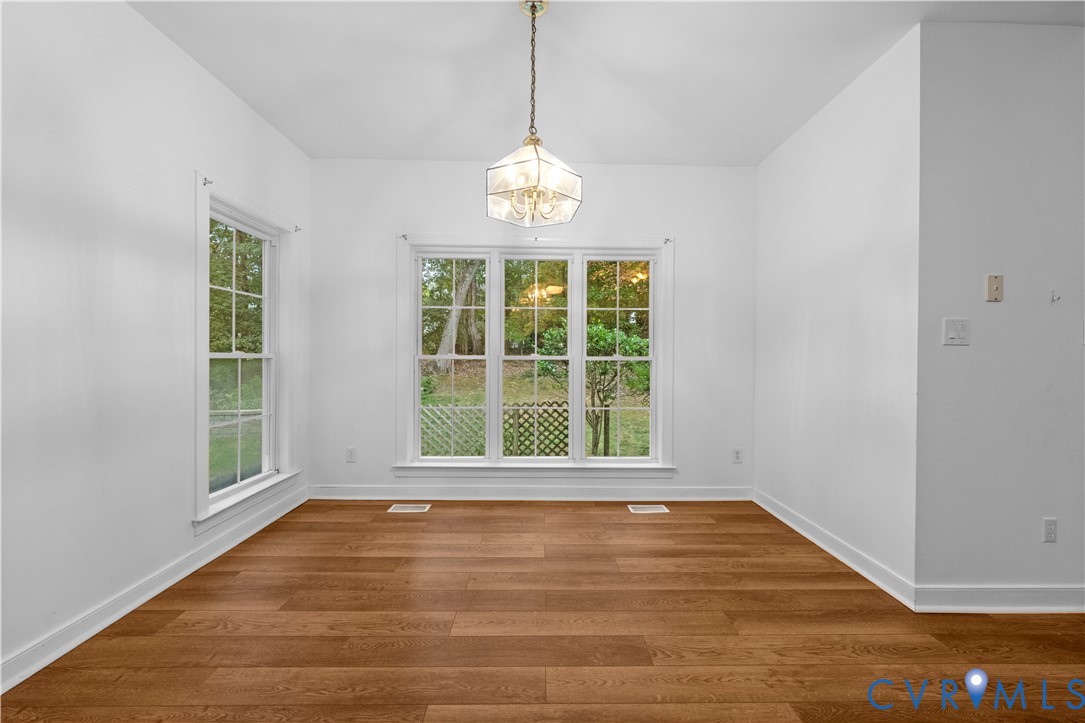 Wood-finish flooring, multi-pane windows, and a geometric pendant light fixture