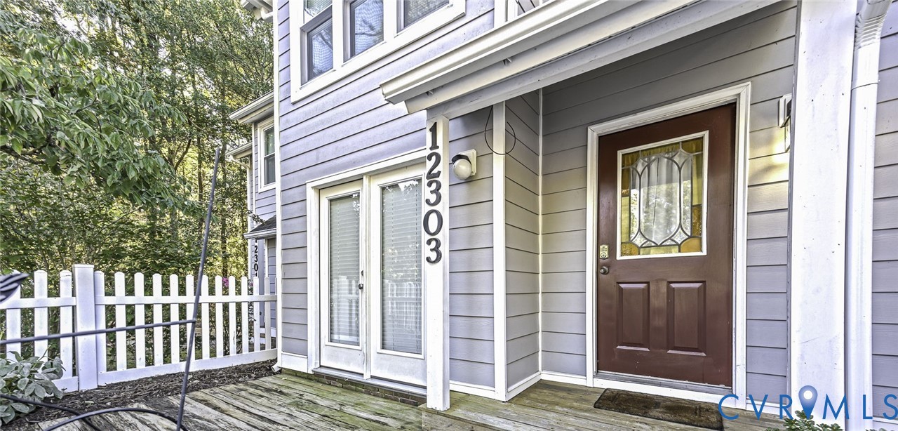 Covered exterior and a wooden deck with French door entry to kitchen. Great for entertaining. Covered exterior and a wooden deck with French door entry to kitchen. Great for entertaining.