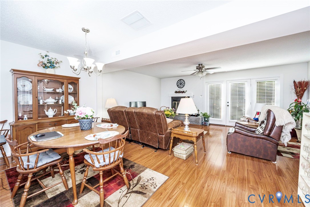 Open living space with a fireplace and raised hearth.