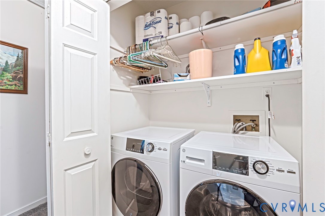 Convenient upstairs laundry closet featuring with built-in shelves.