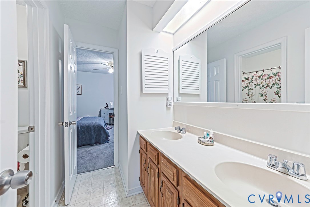Dual-sink vanity with lots of storage and wall-to-wall mirror.