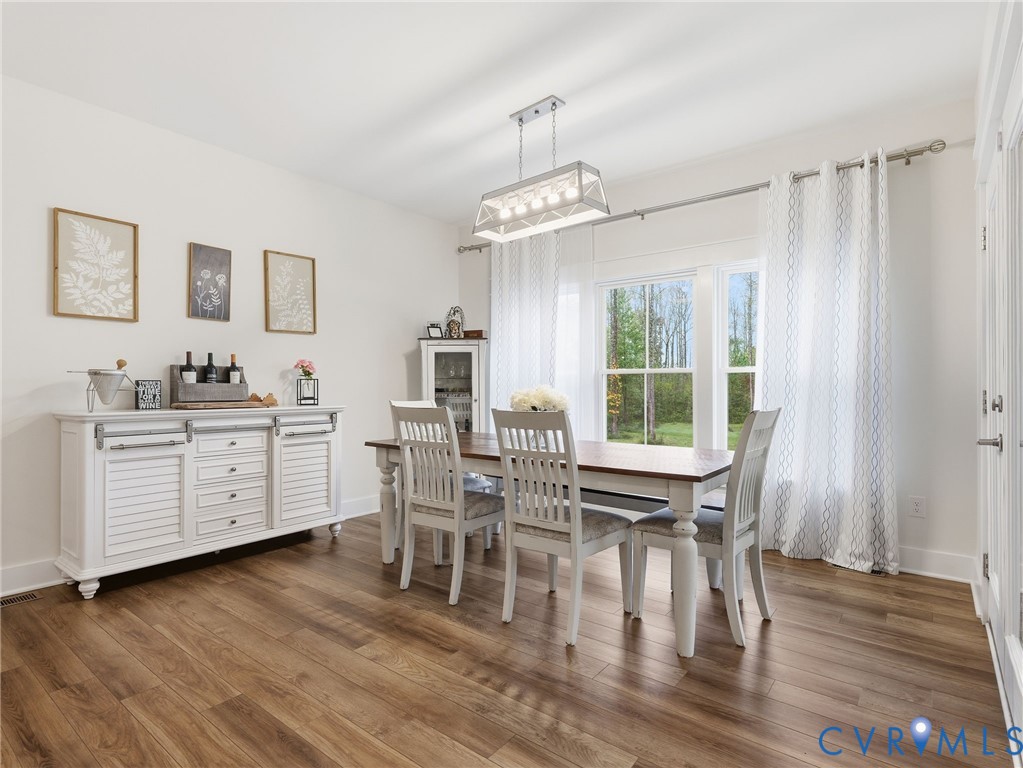Wood-finish flooring, rectangular multi-light pendant fixture, and double-hung windows