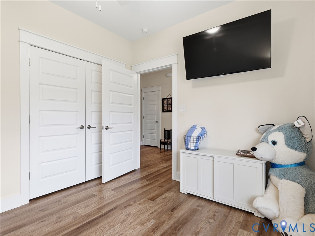 Wood-finish flooring, white five-panel interior doors, and crisp white door casings throughout