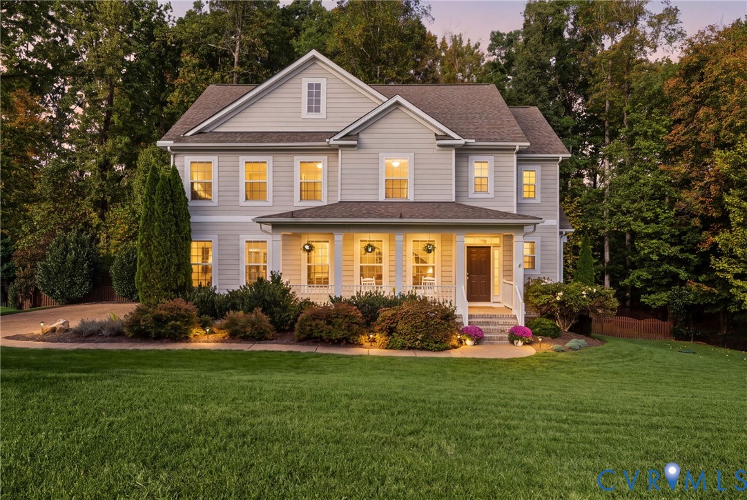 Traditional-style exterior featuring horizontal siding, a covered front porch with column supports, multi-pane windows, and a multi-gabled roofline Traditional-style exterior featuring horizontal siding, a covered front porch with column supports, multi-pane windows, and a multi-gabled roofline