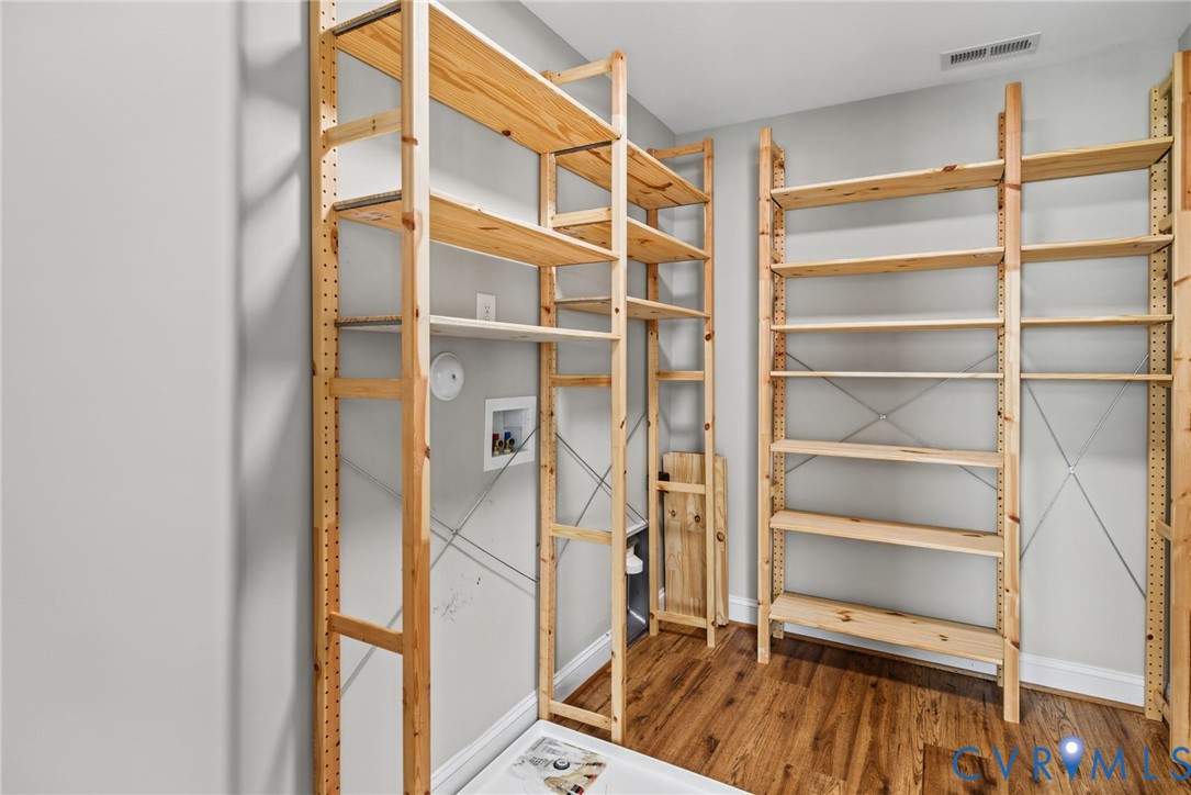 Wood-finish flooring and multiple levels of built-in open pine shelving
