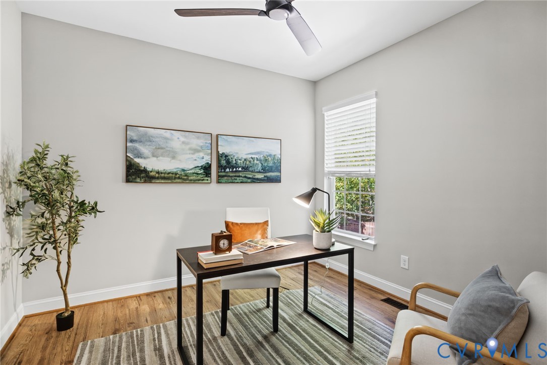 Room featuring wood-finish flooring, a neutral wall palette, a ceiling fan with integrated lighting, and a window with horizontal blinds