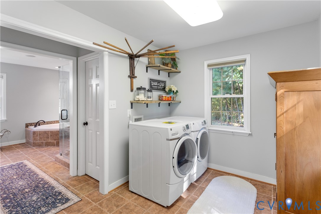 1st floor Laundry room featuring tile flooring, wall-mounted wooden shelving does not convey, a window  more natural light! everywhere!