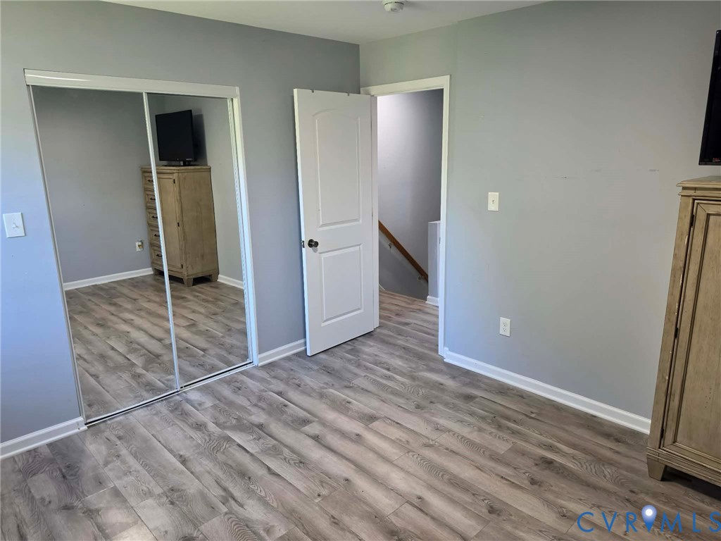 Bedroom #1 featuring LVP and a spacious closet.