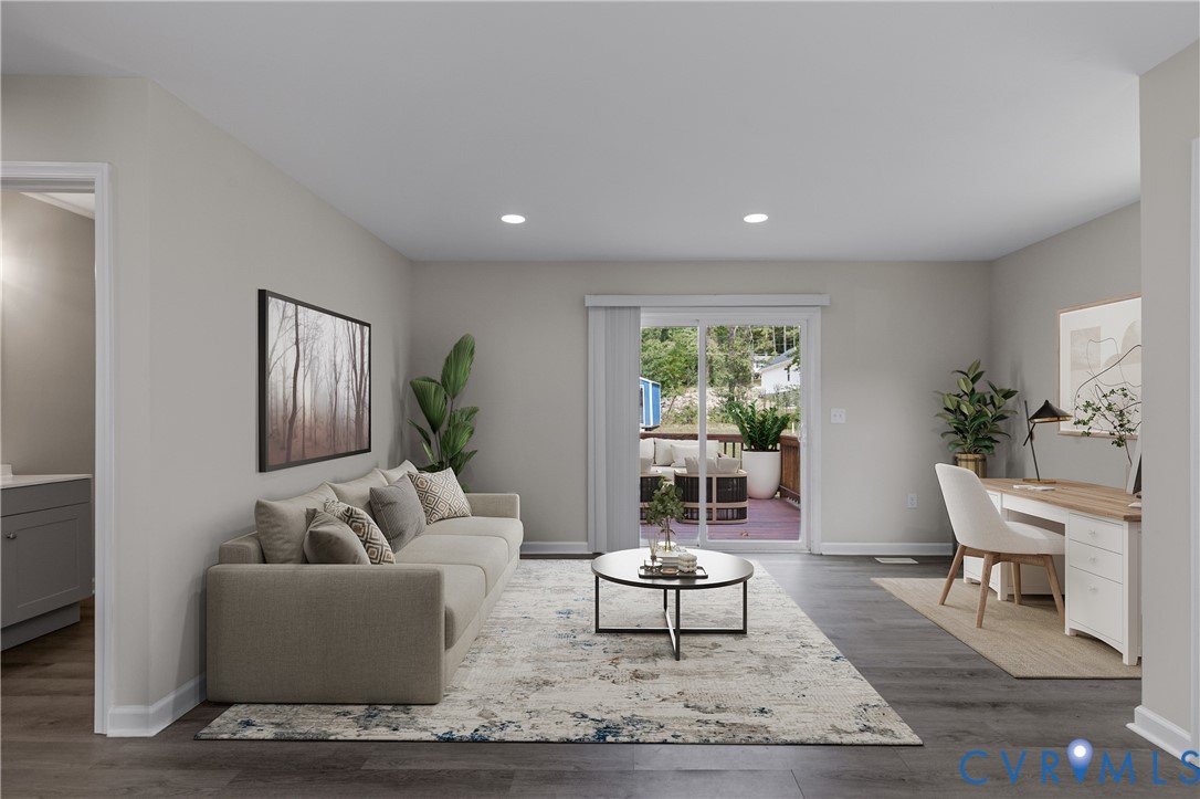 Open-concept room featuring wood-finish flooring, recessed lighting, and a sliding glass door providing external access