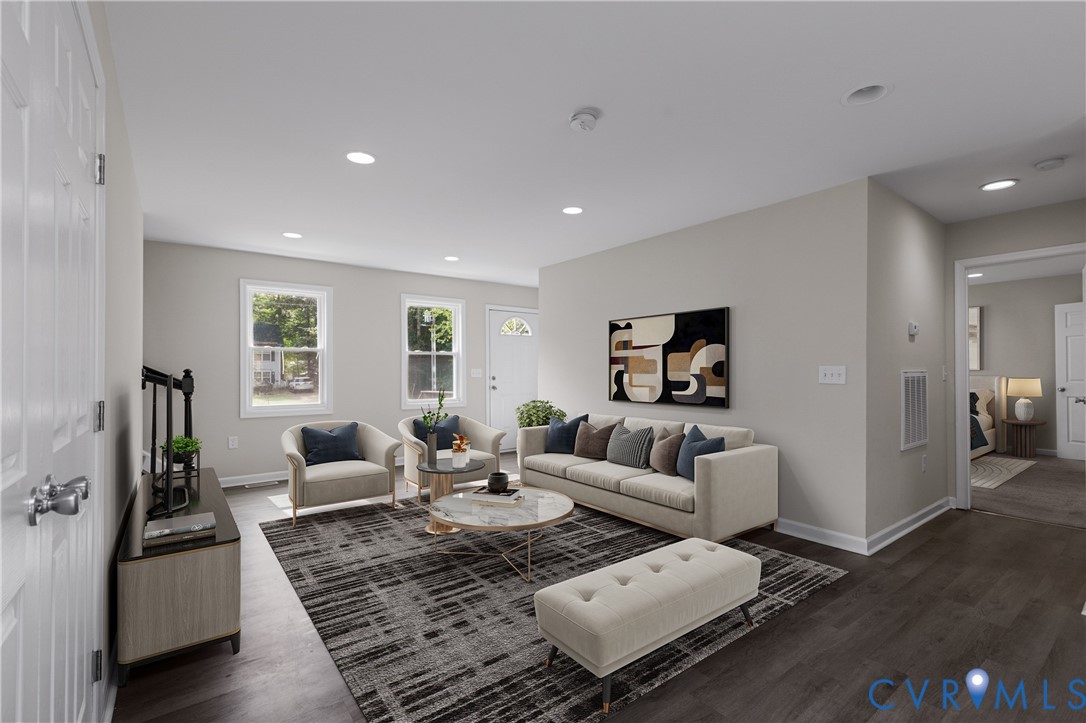 Neutral-toned living space featuring recessed lighting, multi-pane windows, and wood-finish flooring