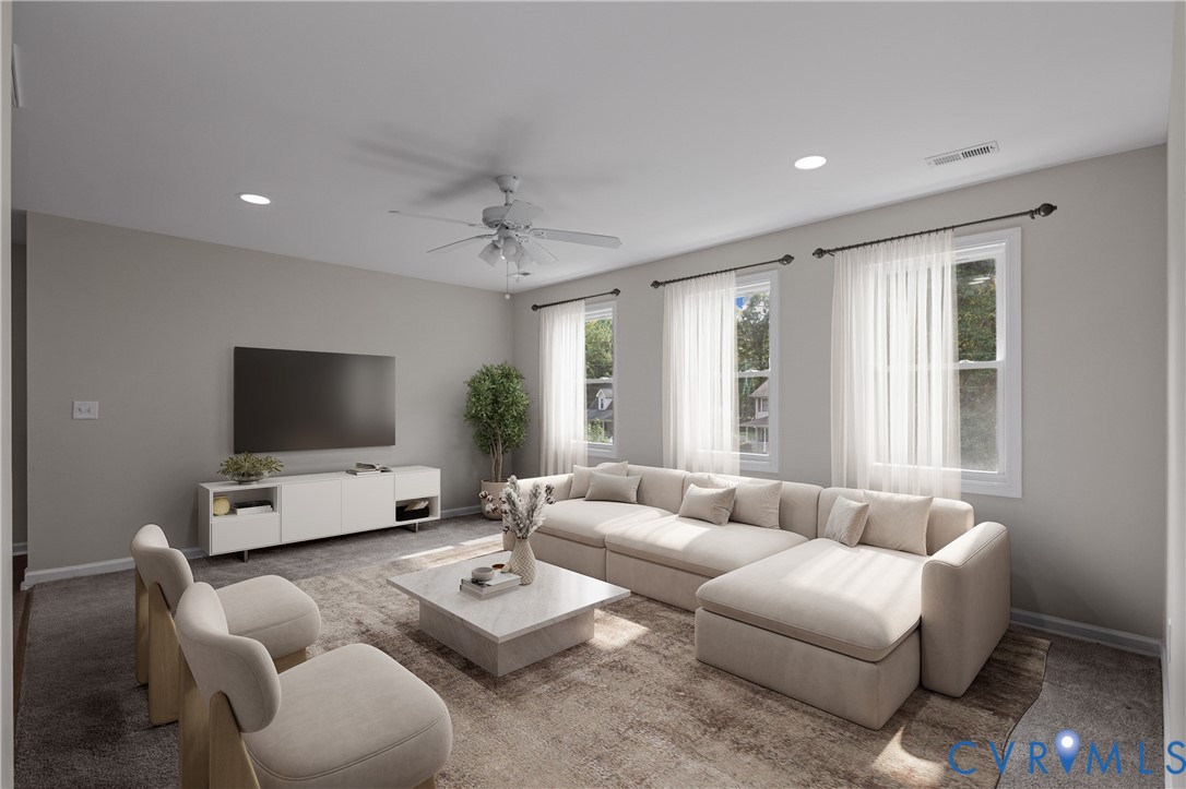 Living area featuring recessed lighting, three windows with drapery hardware, and a ceiling fan with integrated lighting
