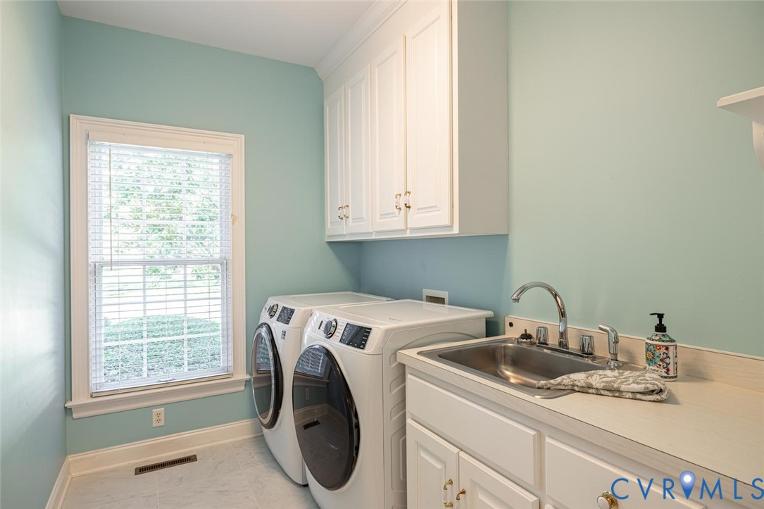First floor laundry room with  sink and cabinets