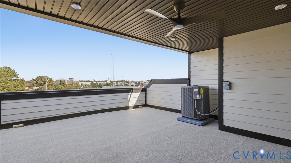 Covered balcony featuring horizontal lap siding, recessed lighting, a modern ceiling fan, and composite decking