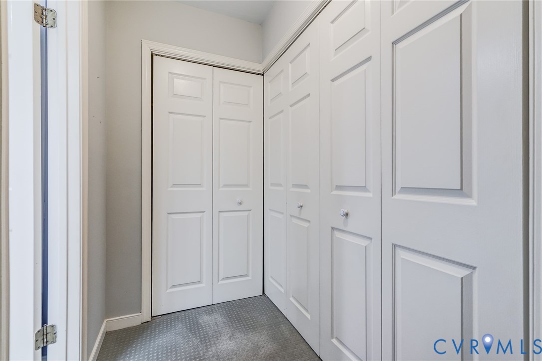 Built-in closets with white multi-panel bi-fold doors and circular hardware