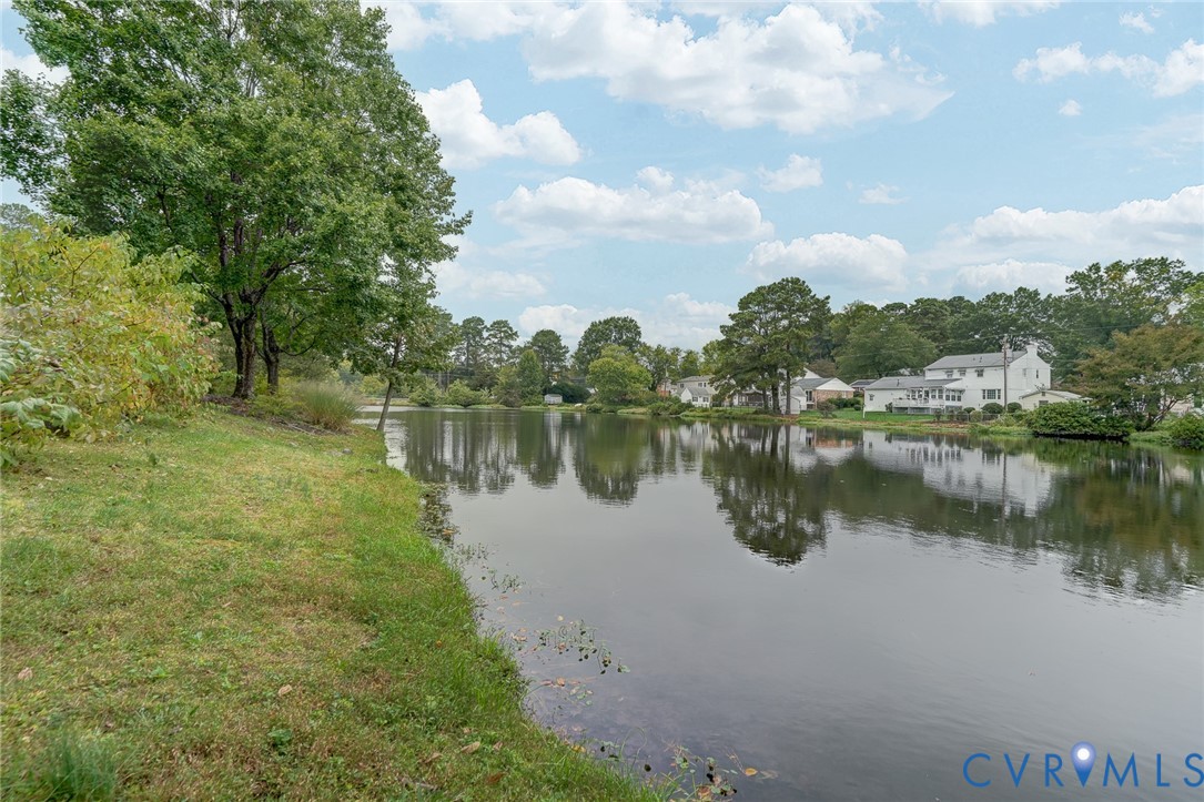 Waterfront parcel featuring mature trees, natural vegetation, and expansive open space