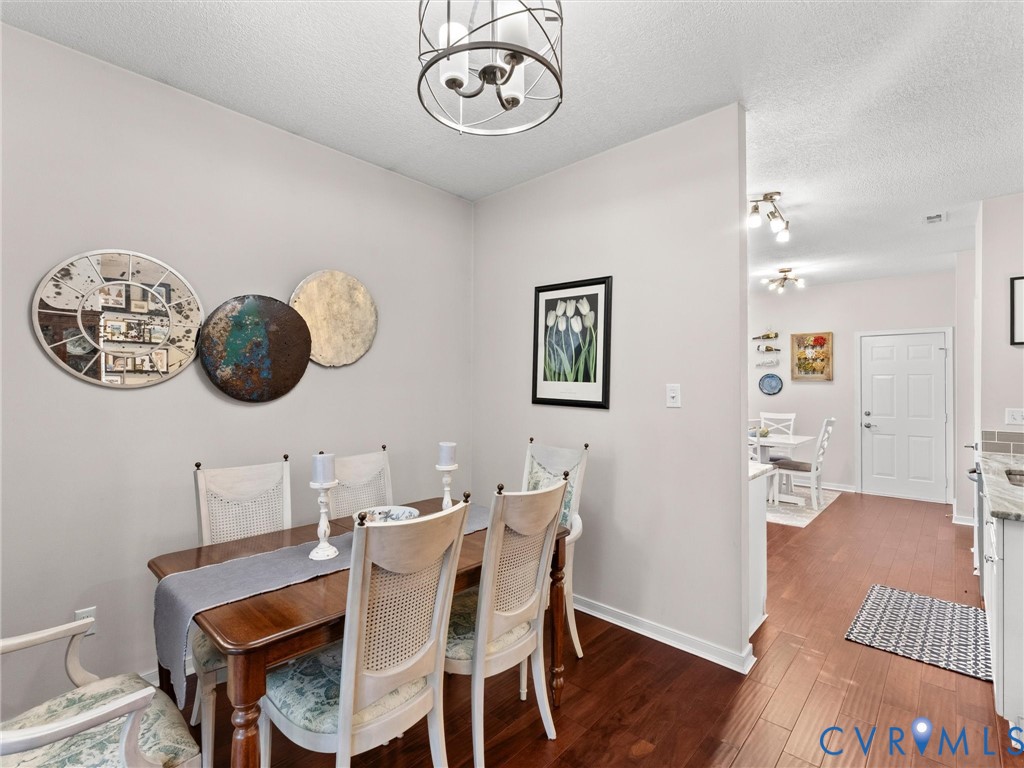 Dining area featuring wood-finish flooring, a drum-style chandelier, and recessed ceiling lighting