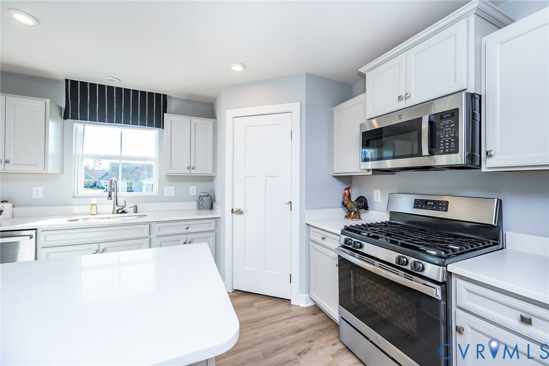 Kitchen featuring Walk In Pantry & Gas Stove with Microwave above